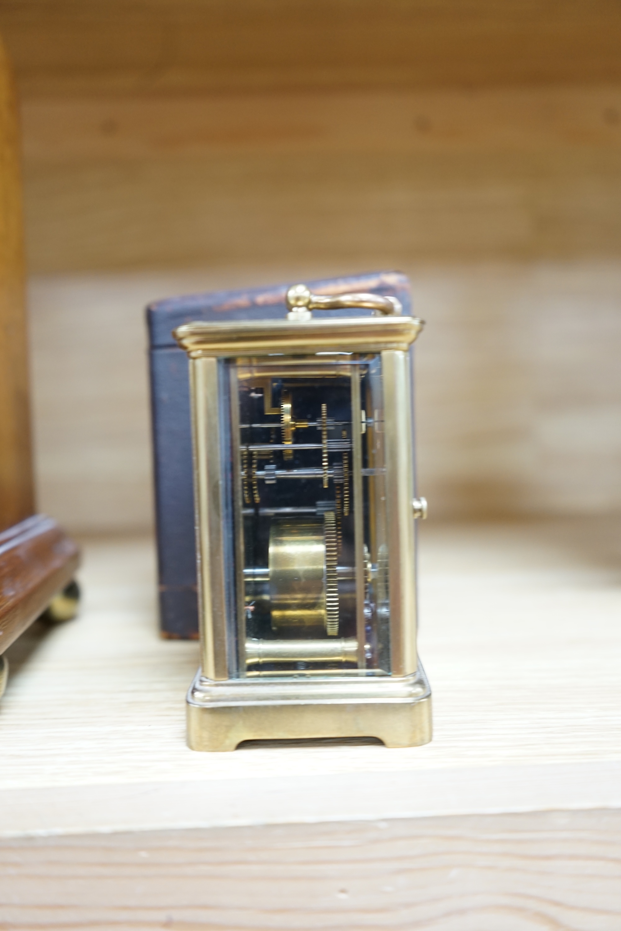 A cased brass carriage timepiece and a dome topped Edwardian mantel clock striking on a coiled gong, backplate stamped BTG, 29.5cm (2) Condition - fair to good.